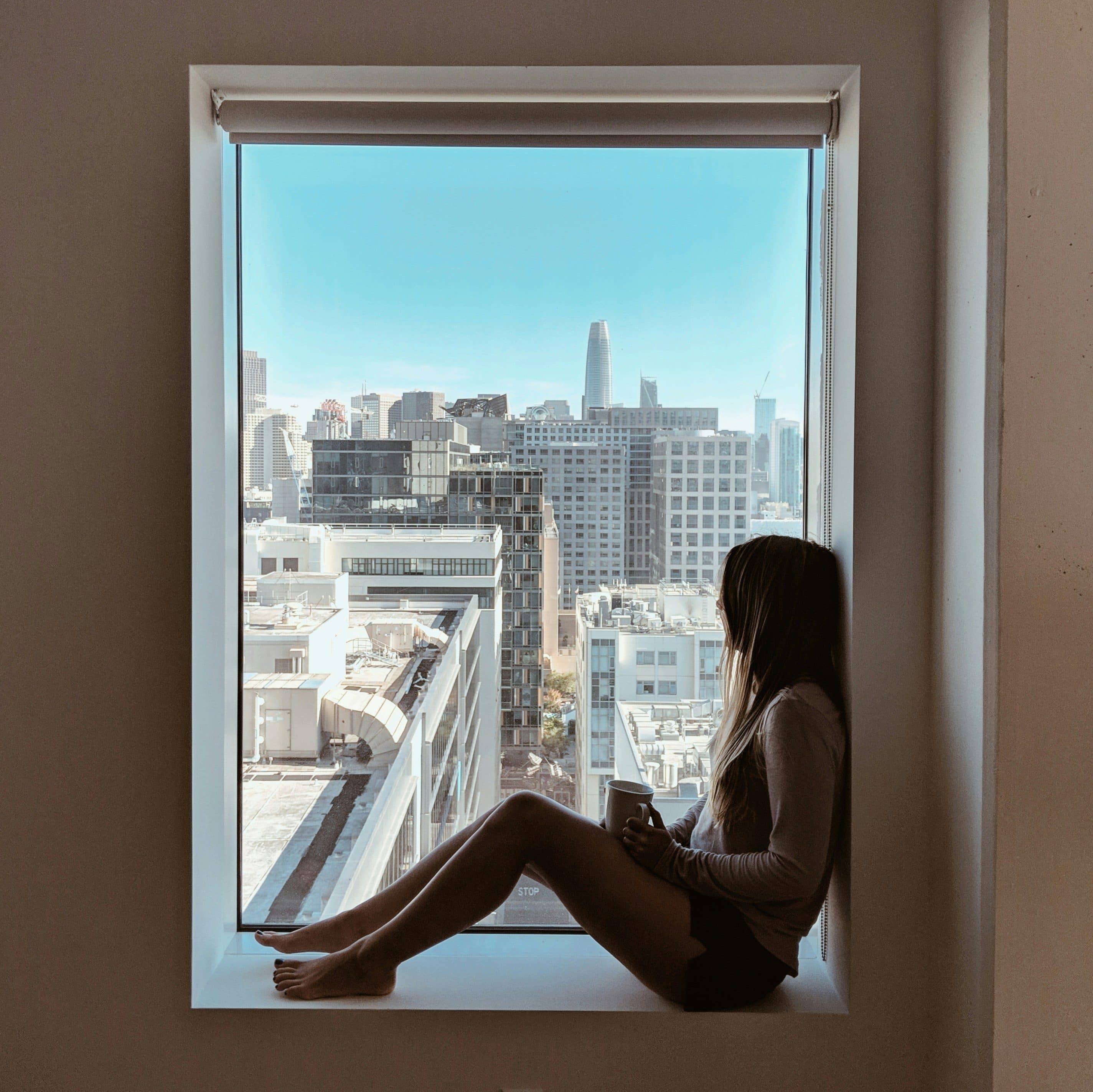Person sitting alone in a quiet room, reflecting on feeling emotionally empty despite life looking fine