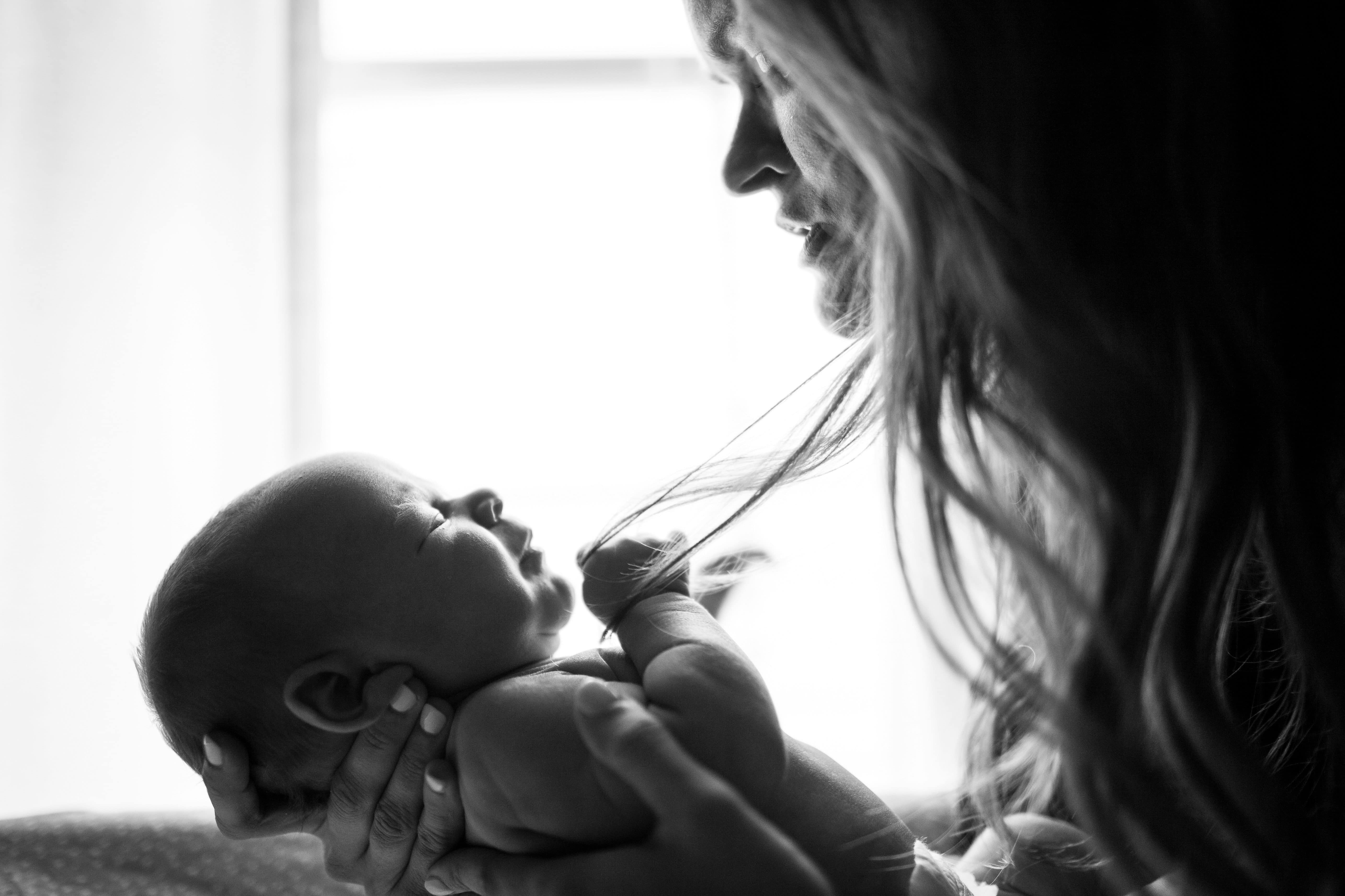 New parent resting in a quiet moment, representing the exhaustion and anxiety of the postpartum period