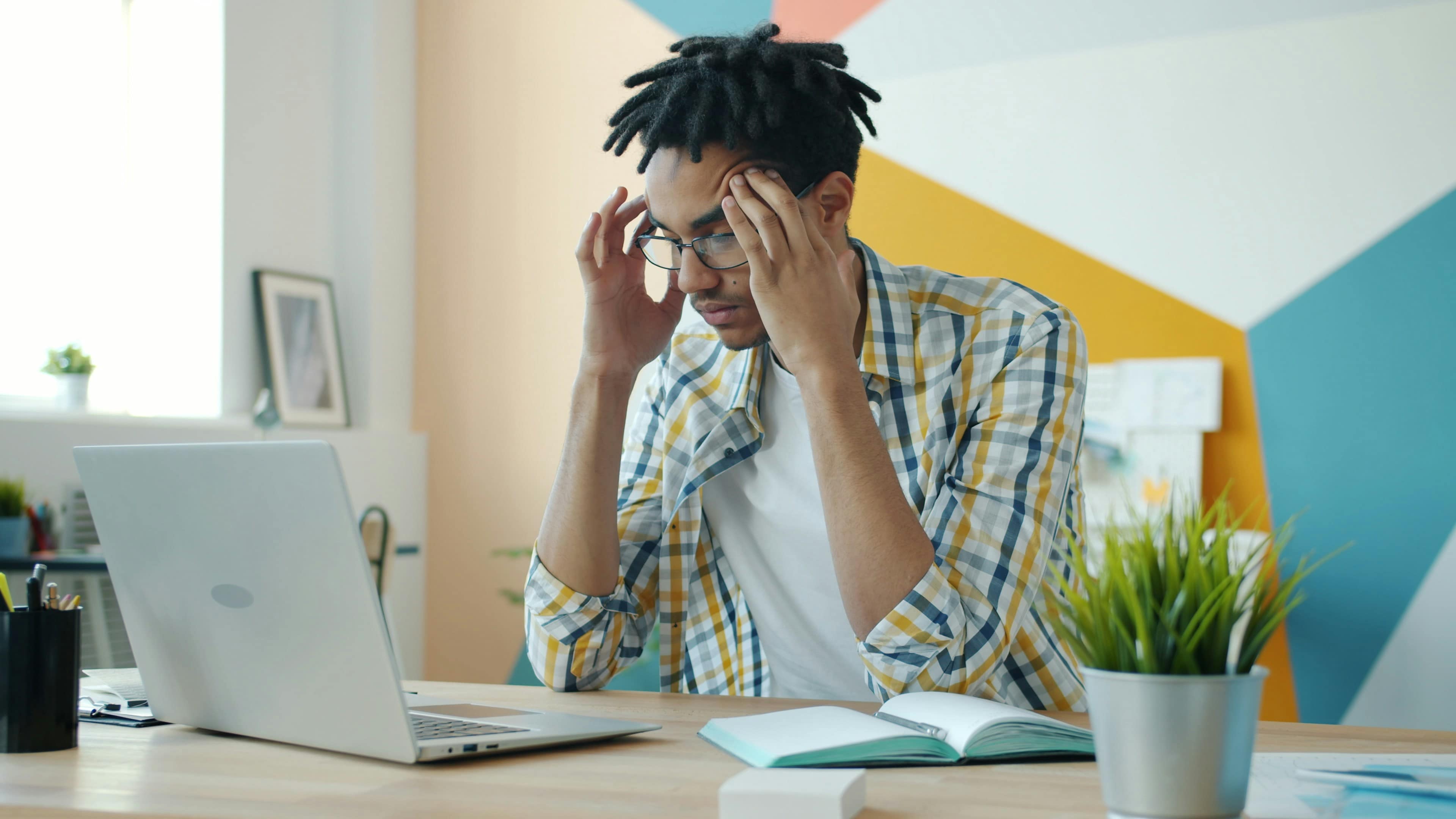 Person looking thoughtful and uncertain despite visible achievements, representing imposter syndrome